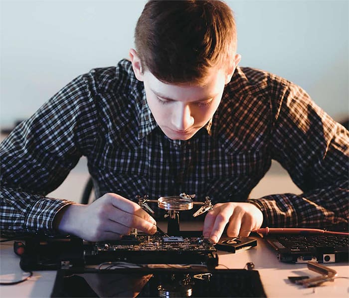 A guy is working on a motherboard