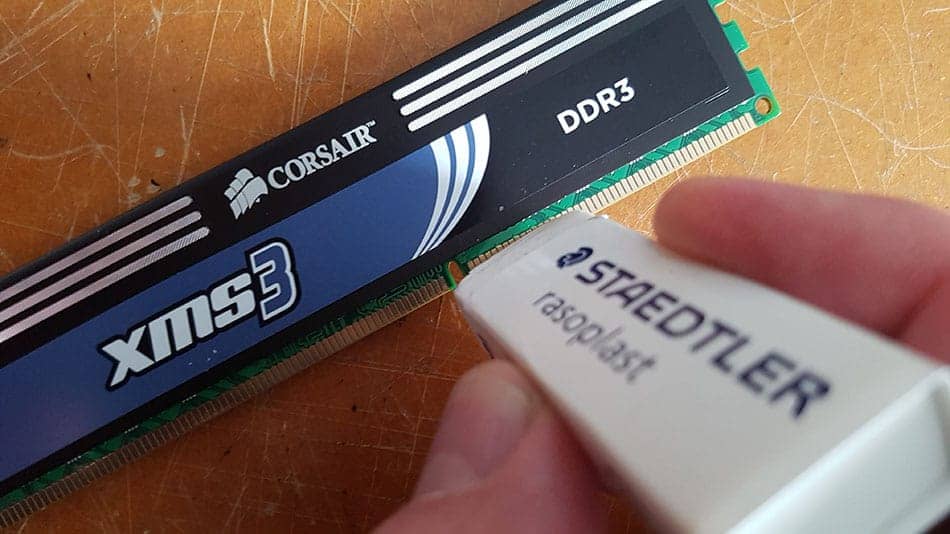 Cleaning RAM contacts using an eraser.