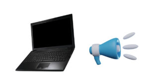 A laptop with a megaphone beside to it.