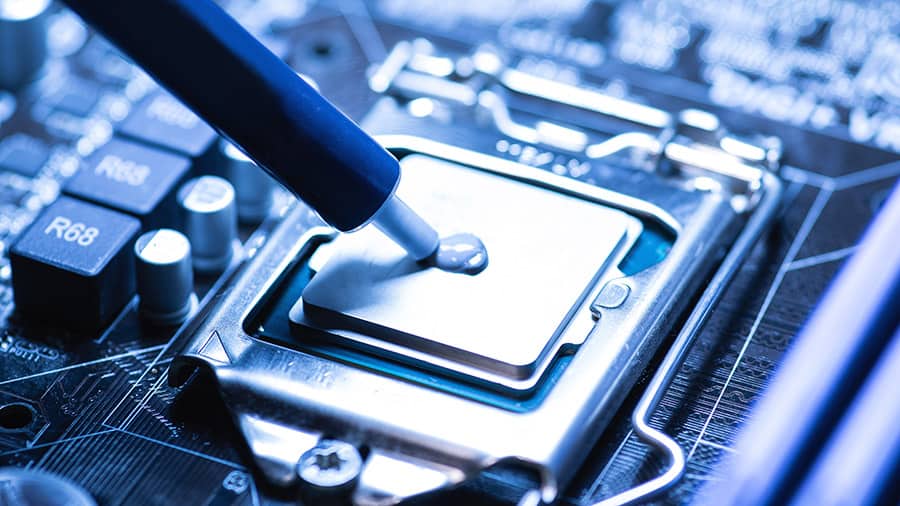 Thermal paste is being applied to a CPU.