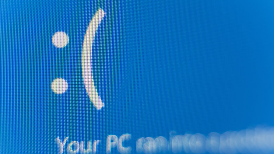 A blue screen on a computer zoomed into the unhappy face on the screen.