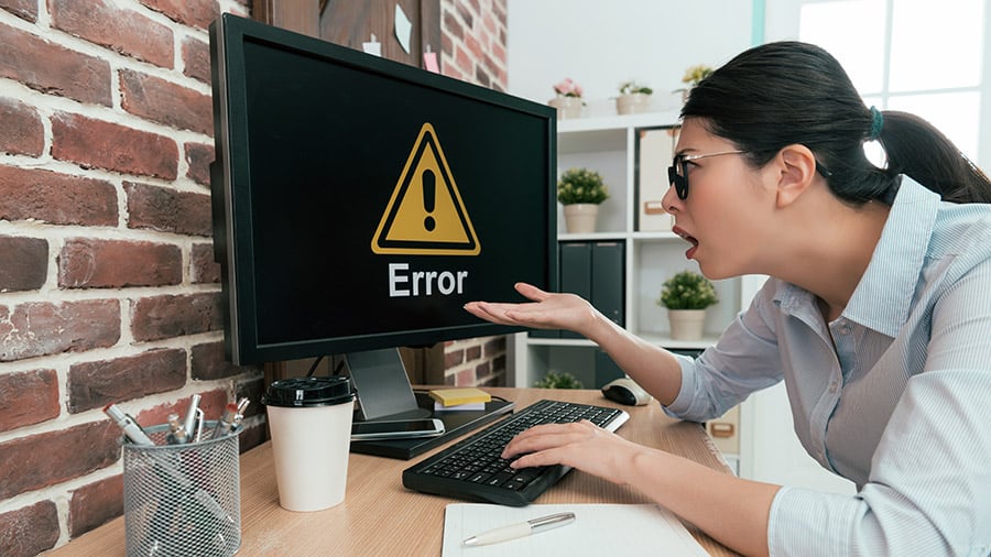 Computer error with a concerned woman staring at the screen.