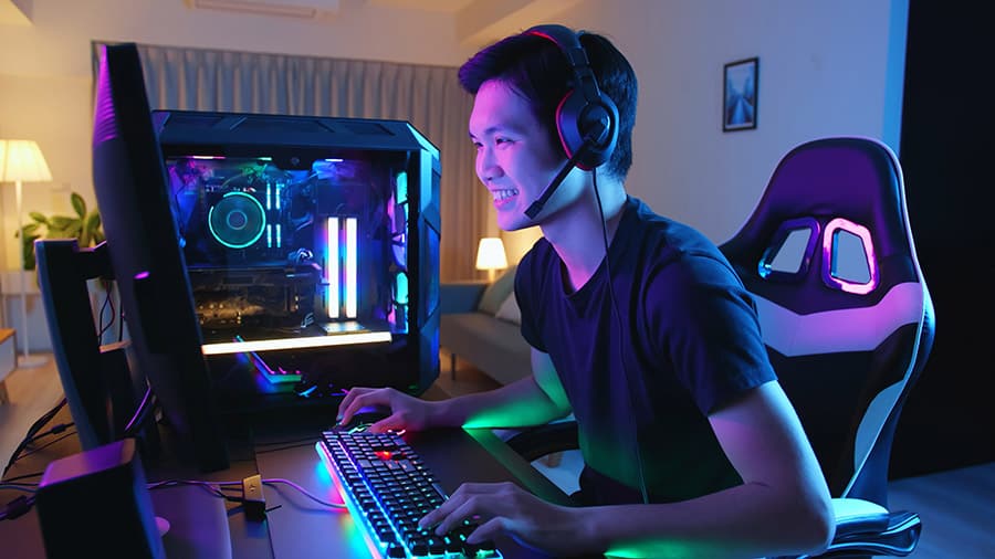 A young man playing a PC video game.