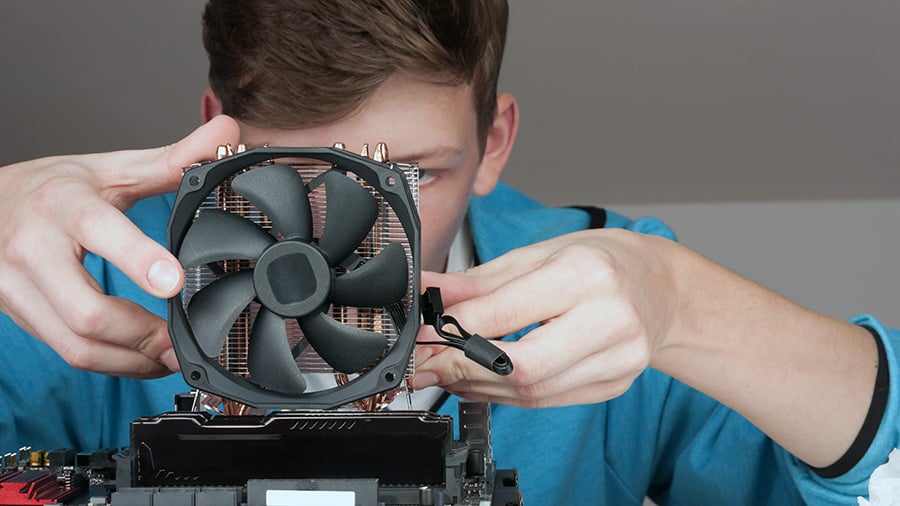 Someone is inspecting the mounting of a CPU cooler.