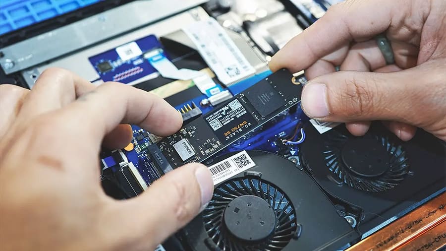 Installing an M.2 SSD into a laptop.