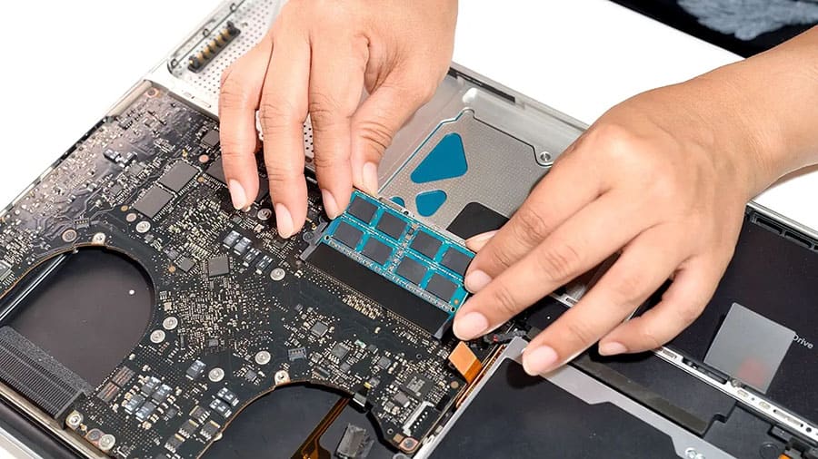 Laptop memory is being installed into a laptop.