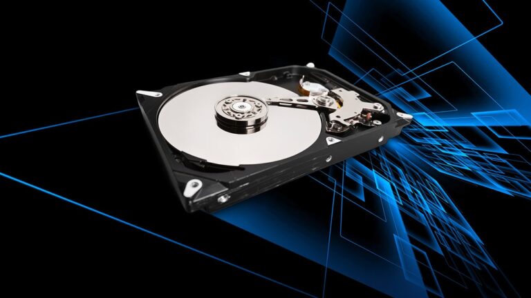 An open mechanical hard disk drive overlayed on a technology abstract design background.