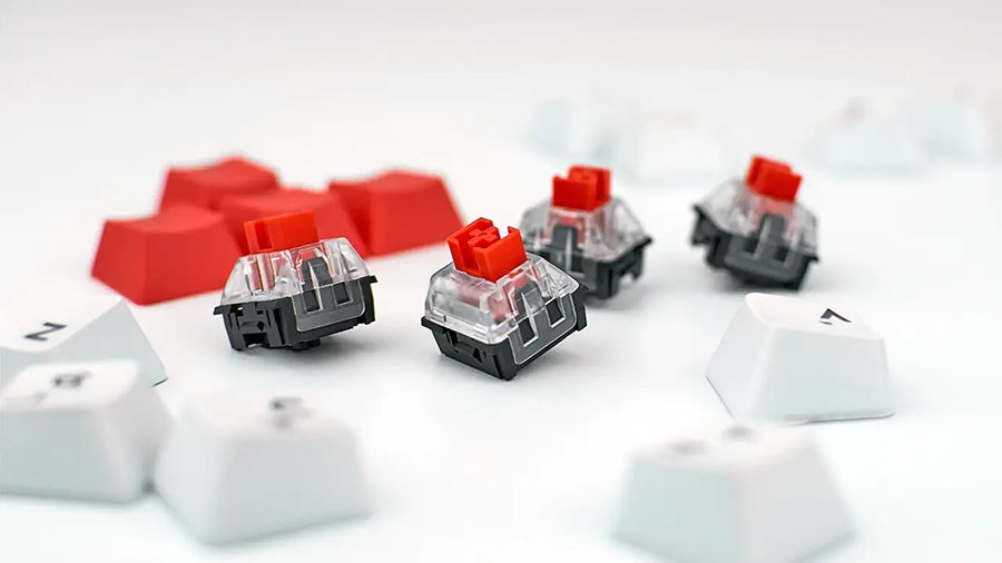 Switches from a mechanical keyboard are laid out on a table surface.