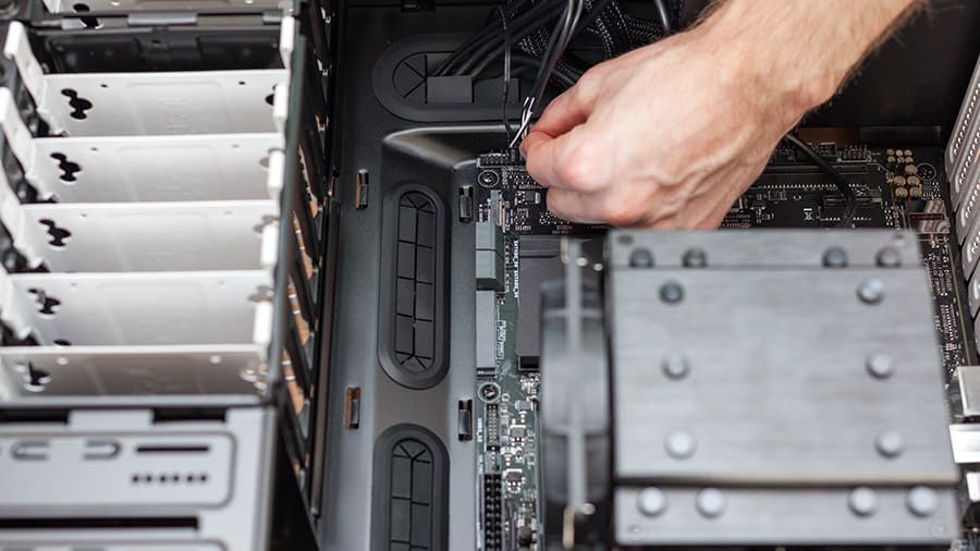 Someone is removing the power switch front panel connector from the motherboard.