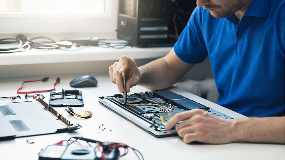 A man is repairing a laptop.