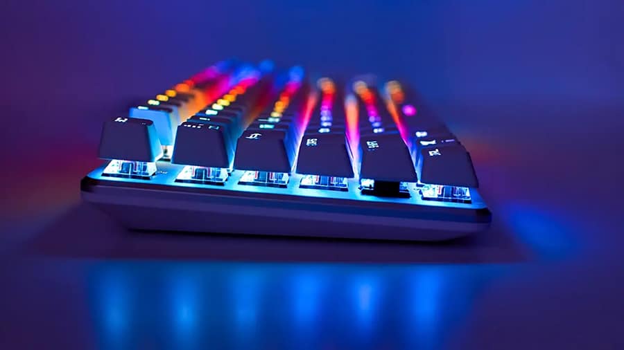 The side view of a mechanical RGB lit keyboard.