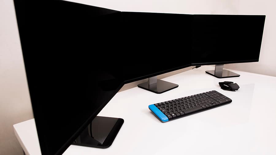Three computer monitors are optimally placed for gaming.