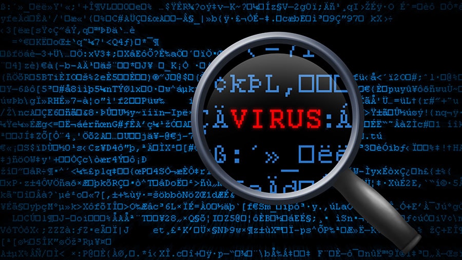 Virus is made out in red letters with a magnifying glass amongst ASCII text to represent finding a virus on a computer.