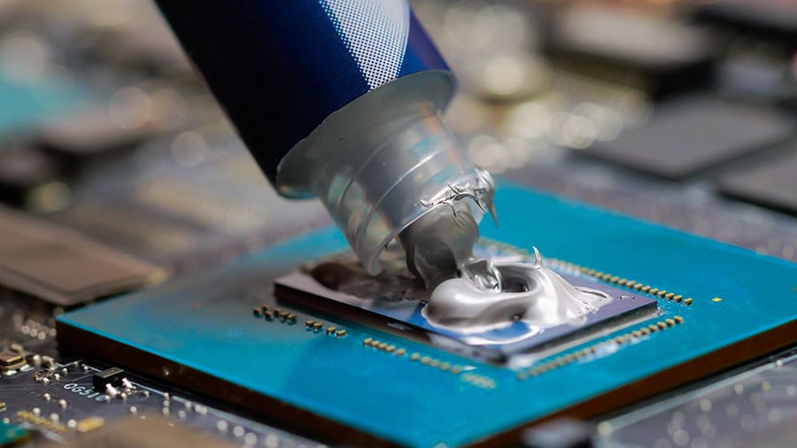 Applying fresh thermal paste to a GPU.