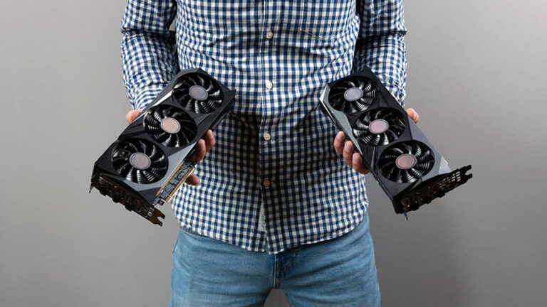 Someone holding two graphics cards.