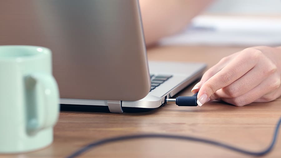 Plugging in a laptop charger.