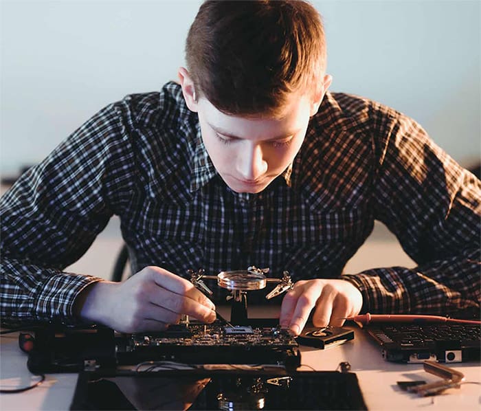 A guy is working on a motherboard.